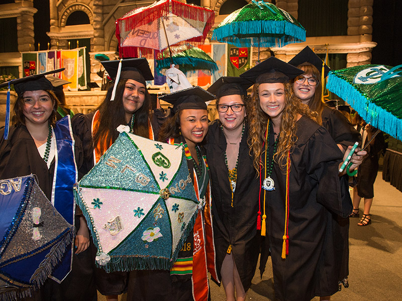 Students at commencement holding second-line umbrellas